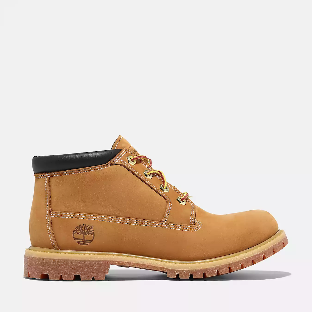 Timberland® Nellie Waterproof Chukka Boot for Women in Wheat. Wheat-colored leather chukka boot featuring waterproof construction for dry feet, padded collar for comfort, anti-fatigue technology for all-day support, and a lug outsole for traction. Pairs well with jeans, leggings, or skirts for a versatile look.