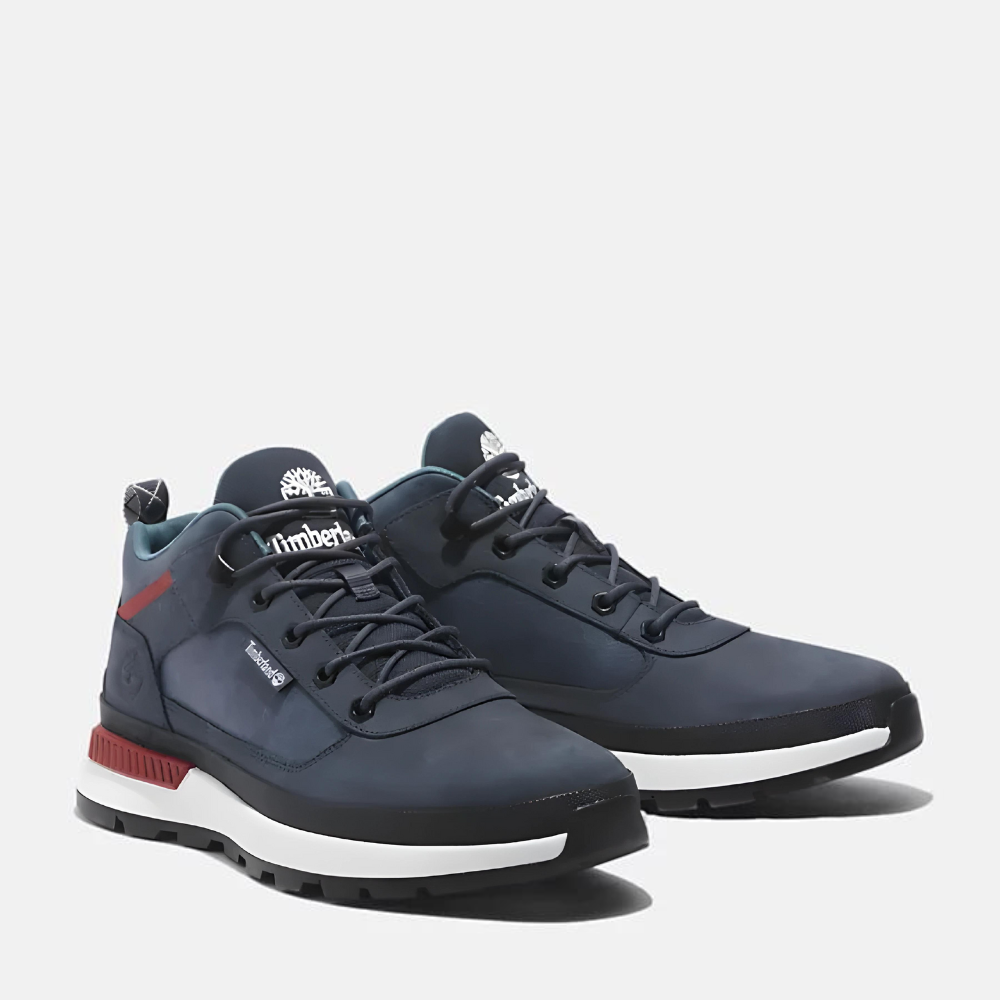 Timberland® Field Trekker Low Lace Up Sneaker for Men. Dark blue nubuck sneaker featuring lace-up closure for a secure fit, cushioned footbed for comfort, water-resistant construction for dry feet, and lugged outsole for traction. Made with partly recycled materials. Pairs well with casual outfits.