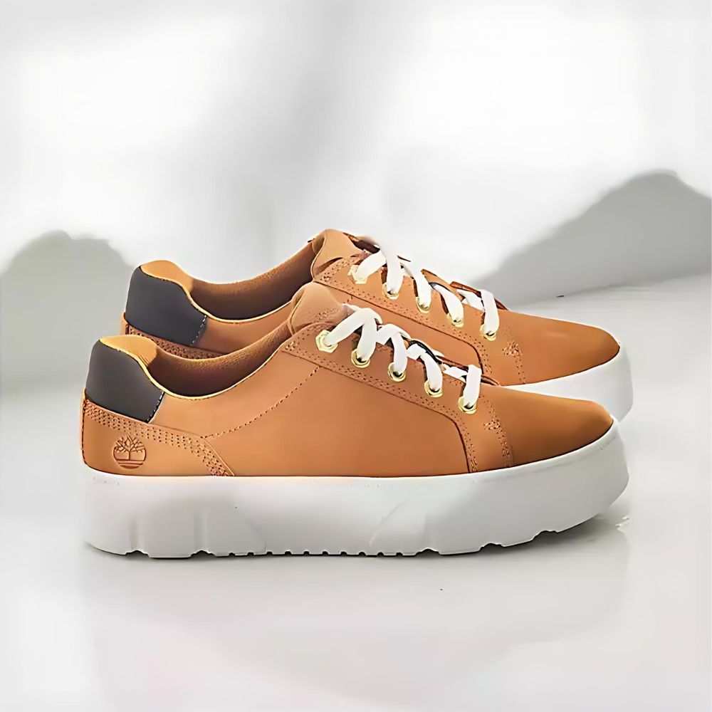 Wheat Timberland® Laurel Court Sneaker. Women's sneaker with eco-conscious materials (recycled fabric, laces) for everyday comfort. OrthoLite® footbed for cushioning. Lace-up closure, durable outsole. Pairs well with jeans, leggings, or skirts.