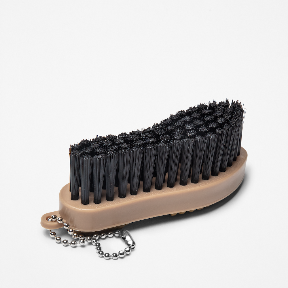 TimberlandÂ® Rubber Sole Brush. Handheld brush with stiff bristles specifically designed for cleaning dirt, mud, and debris from the soles of shoes with rubber treads. Features a comfortable grip for ease of use.