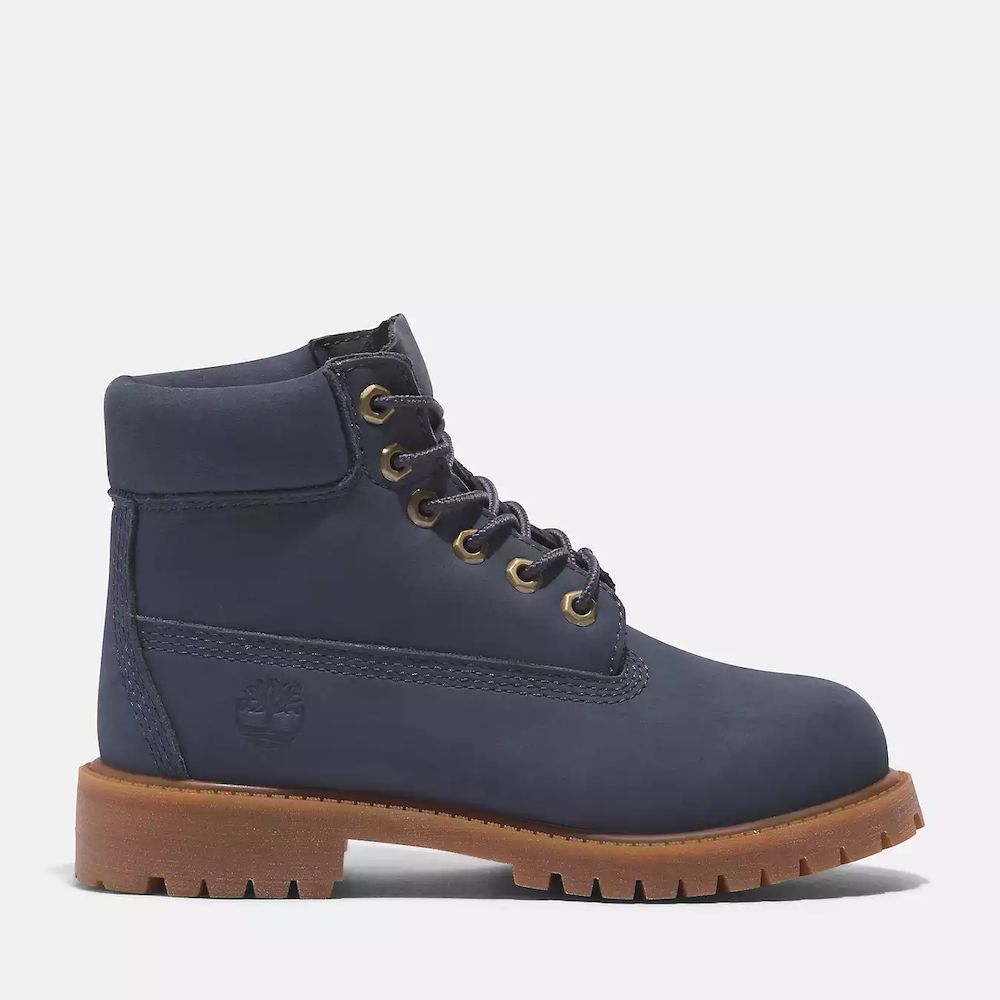 Timberland® Premium 6-Inch Lace Up Waterproof Boot for Junior. Dark blue waterproof boot featuring seam-sealed construction, padded collar for comfort, signature lug sole for traction, and lace-up closure for a secure fit. Perfect for outdoor adventures.