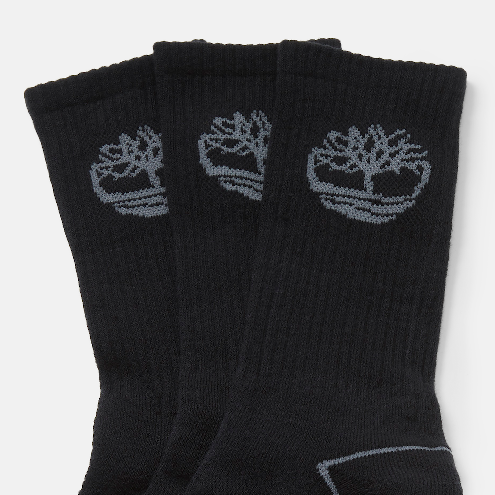 Timberland® Bowden 3-Pack Logo Crew Socks for Men in Black. Three-pack of black crew socks featuring a full cushion construction for comfort, knit-in Timberland® logo across the toe for subtle branding, and a ribbed construction for a stay-up fit. Perfect for everyday wear with boots, sneakers, or casual shoes.