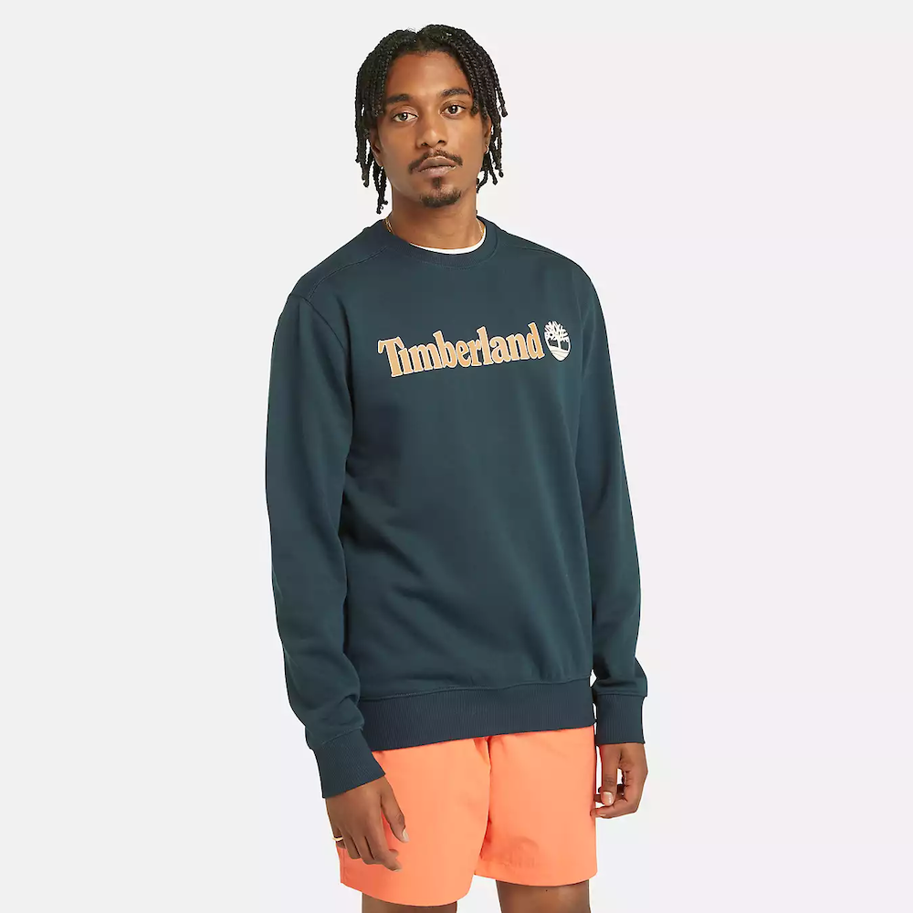 Navy Timberland® Kennebec River Linear Logo Crew Neck Sweatshirt for Men. Soft cotton blend with brushed-back fleece for warmth and comfort. Classic crew neck design. Regular fit for comfortable wear.