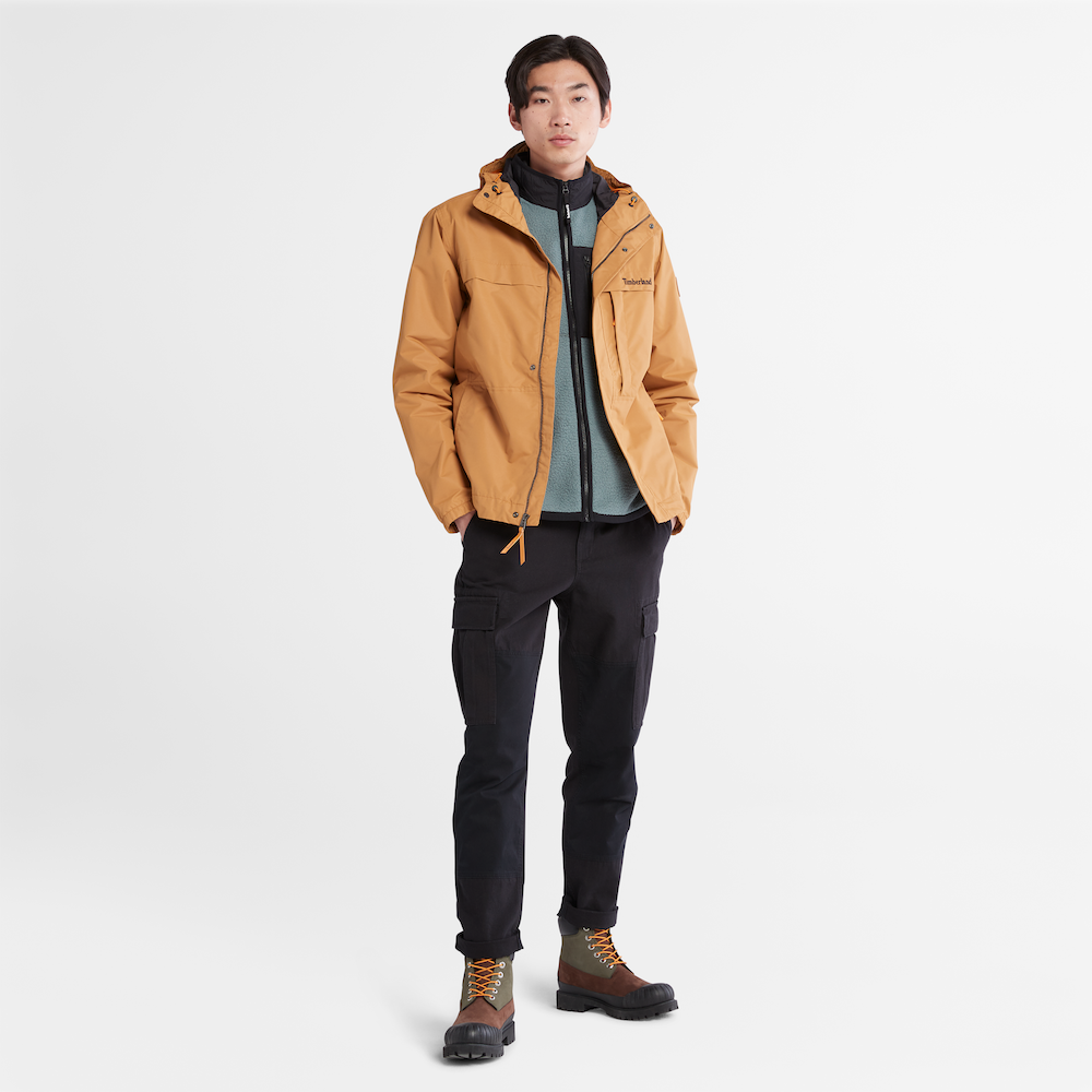 Timberland® Benton Water Resistant Jacket for Men. Wheat jacket made with recycled materials, featuring a water-resistant shell, adjustable hem, and multiple pockets.