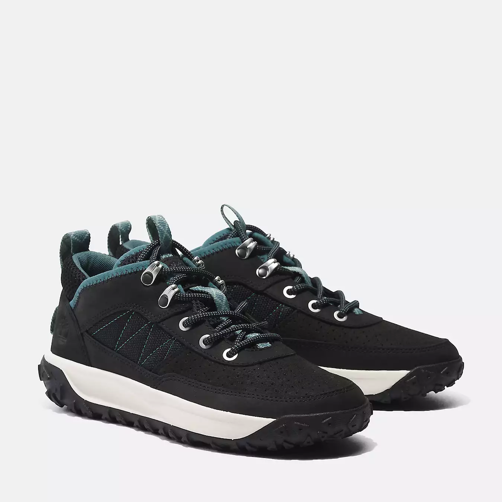 Black and white Timberland® GreenStride™ Motion 6 Low Hiker for Women. Upper in black and white features premium waterproof leather and ReBOTL™ fabric (made with at least 50% recycled plastic) for durability and sustainability. 