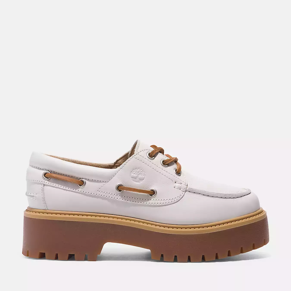 White Timberland® Stone Street Boat Shoe for Women. Premium white leather upper for luxury and durability. 3-eye lace-up closure for secure fit. Padded collar for ankle support. Breathable leather lining. OrthoLite® insoles for comfort and moisture management. Chunky rubber sole for traction and durability