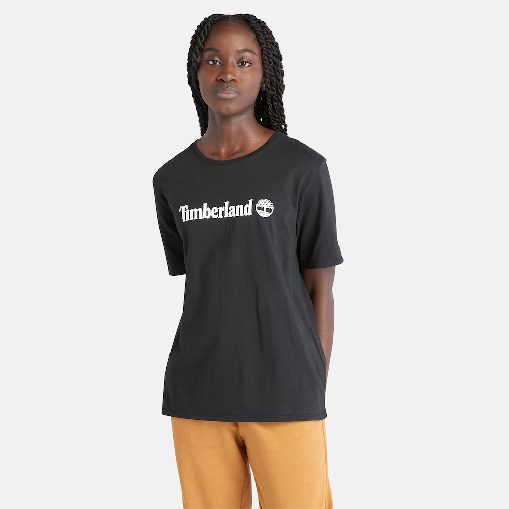 Black Timberland® Logo Short Sleeve Tee for Women. Black crewneck t-shirt made from 100% cotton for a soft and breathable feel. Features a relaxed, regular fit for comfortable wear. A bold Timberland® logo is printed on the chest for a touch of brand flair.
