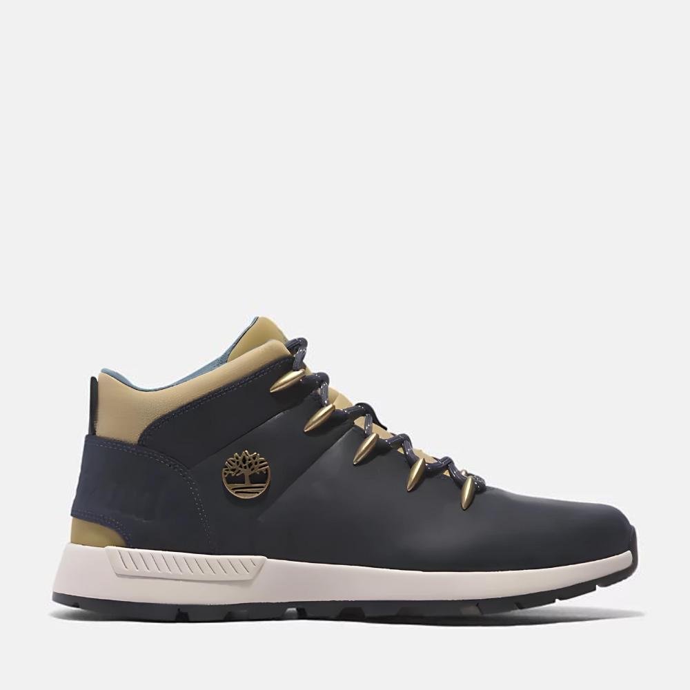 Timberland¡ Sprint Trekker Mid Sneaker for Men. Dark blue full grain leather sneaker with lace-up closure for a secure fit, lightweight construction for comfort, supportive mid-ankle design, and lugged outsole for traction. Pairs well with casual outfits.