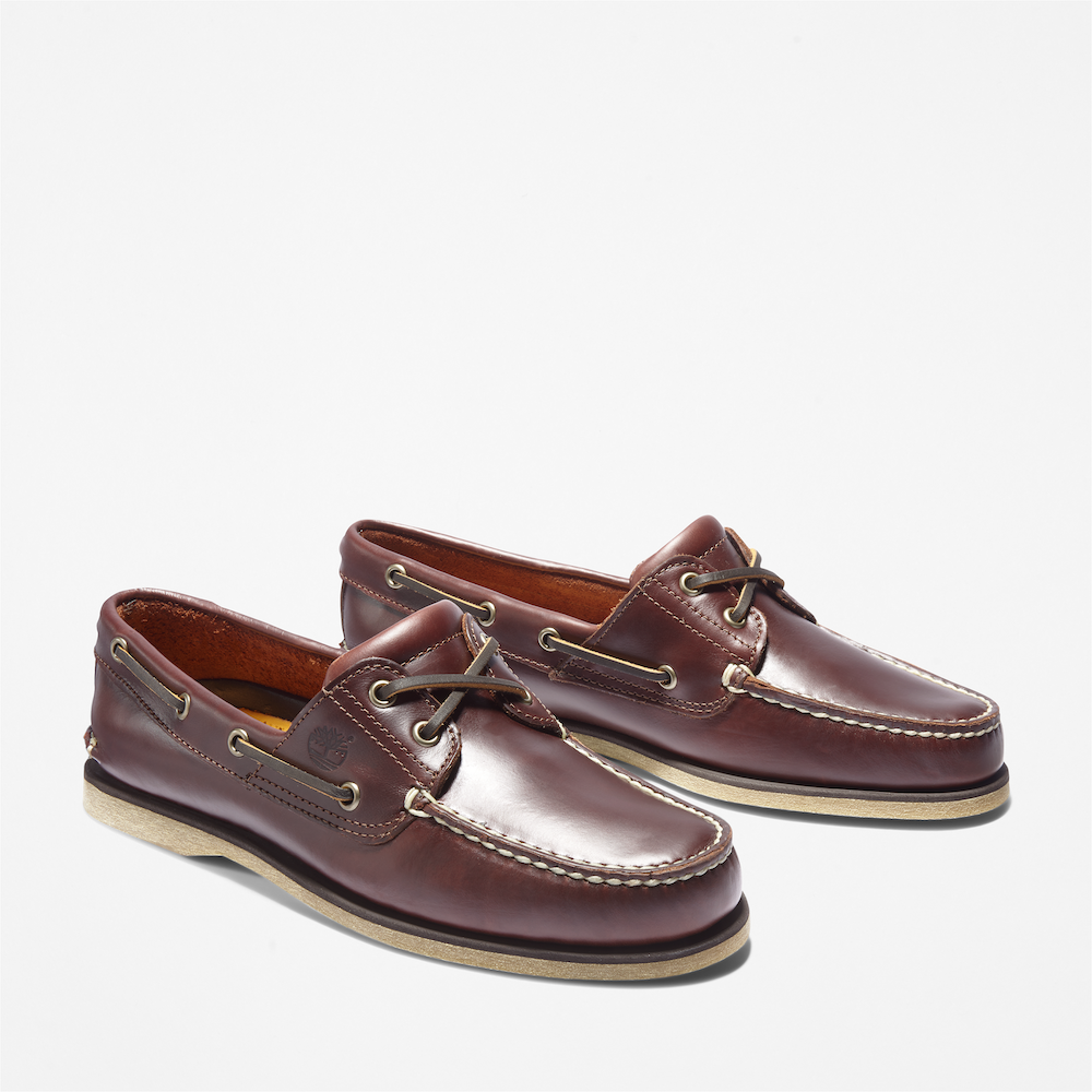 Timberland® Classic 2-Eye Boat Shoe for Men. Dark brown leather boat shoe featuring a hand-sewn construction for durability, 360° lacing system for a secure fit, leather-lined footbed for comfort, and non-marking outsole for traction. Perfect for casual wear or boat days.