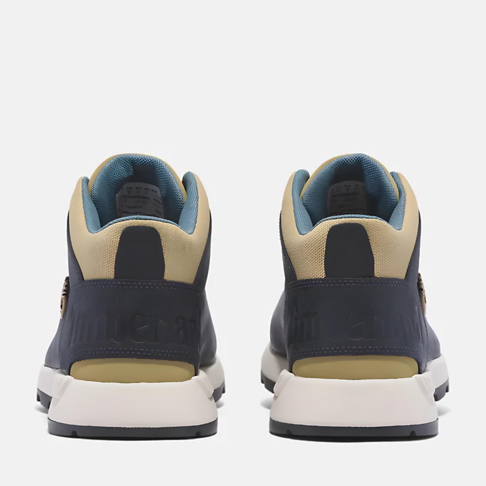 Timberland¡ Sprint Trekker Mid Sneaker for Men. Dark blue full grain leather sneaker with lace-up closure for a secure fit, lightweight construction for comfort, supportive mid-ankle design, and lugged outsole for traction. Pairs well with casual outfits.