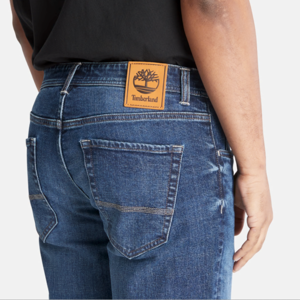 Timberland® Indigo Stretch Denim for Men in Indigo. Made with organic cotton for sustainability and comfort. Slim-fit cut for modern style. Classic 5-pocket design for functionality. Indigo wash for timeless look.