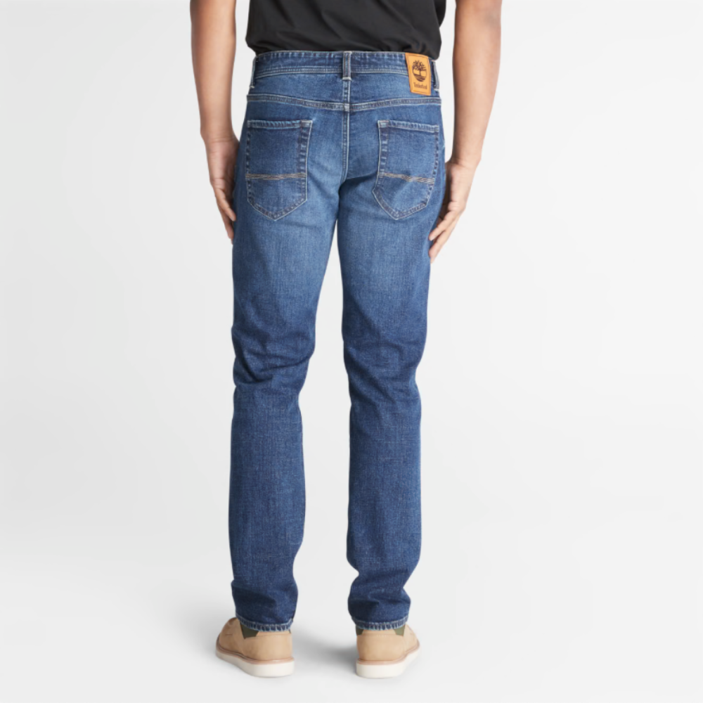 Timberland® Indigo Stretch Denim for Men in Indigo. Made with organic cotton for sustainability and comfort. Slim-fit cut for modern style. Classic 5-pocket design for functionality. Indigo wash for timeless look.