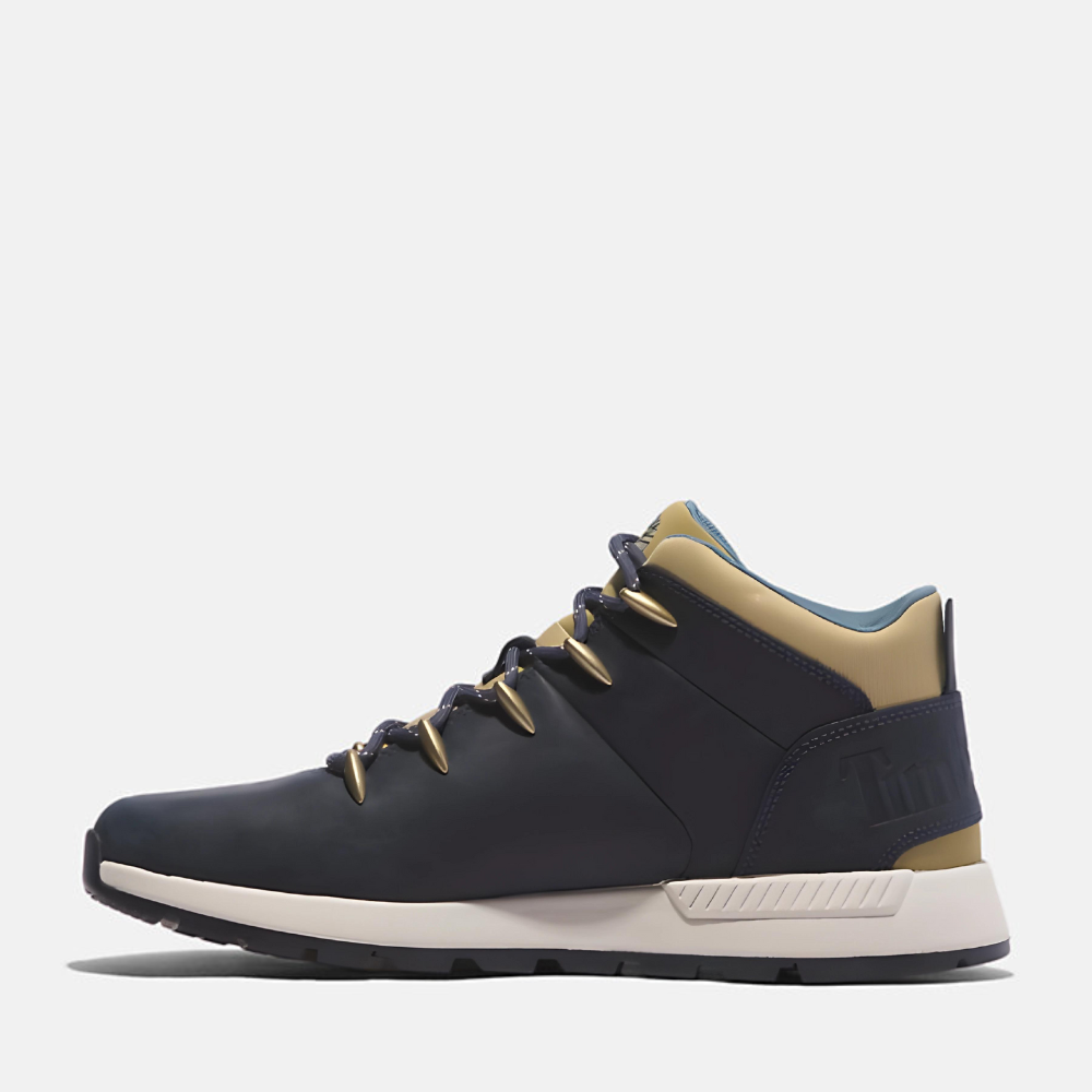 Timberland¡ Sprint Trekker Mid Sneaker for Men. Dark blue full grain leather sneaker with lace-up closure for a secure fit, lightweight construction for comfort, supportive mid-ankle design, and lugged outsole for traction. Pairs well with casual outfits.