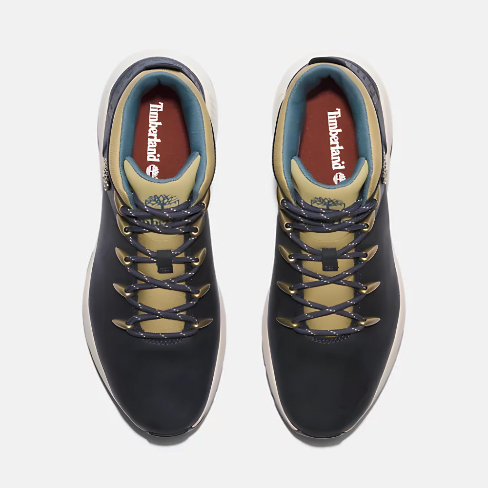 Timberland¡ Sprint Trekker Mid Sneaker for Men. Dark blue full grain leather sneaker with lace-up closure for a secure fit, lightweight construction for comfort, supportive mid-ankle design, and lugged outsole for traction. Pairs well with casual outfits.