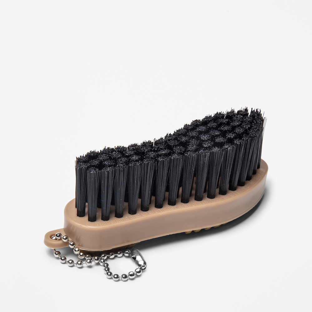 Timberland€š® Rubber Sole Brush. Handheld brush with stiff bristles specifically designed for cleaning dirt, mud, and debris from the soles of shoes with rubber treads. Features a comfortable grip for ease of use.