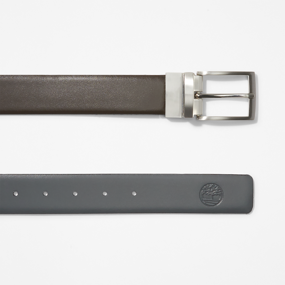 Dark brown Timberland® Reversible Leather Belt. Reversible belt with dark brown and black color options. Made from 100% split cow leather for quality and affordability. Features antiqued silver hardware and a reversible buckle system.  Embossed logo on the tip