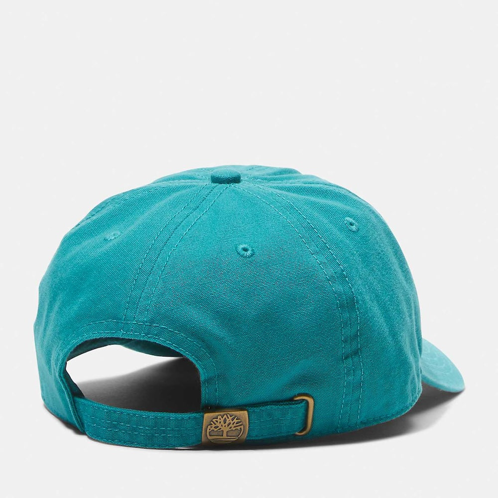 Timberland® Soundview Cotton Canvas Baseball Cap in Teal. Teal cotton canvas baseball cap with embroidered eyelets and adjustable strap. Lightweight and comfortable for casual wear or sun protection. Classic design with a pop of color.