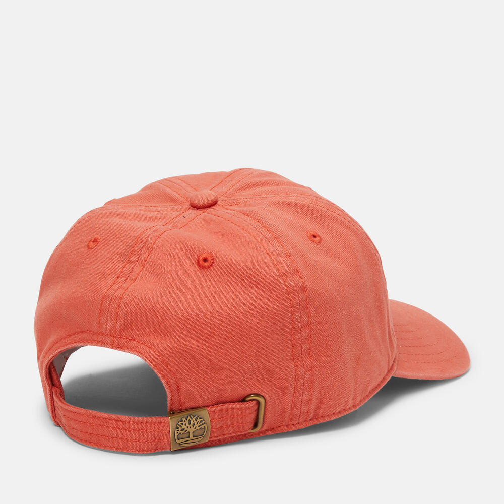 Timberland® Soundview Cotton Canvas Baseball Cap in Coral. Coral cotton canvas baseball cap with embroidered eyelets and adjustable strap. Lightweight and comfortable for casual wear or sun protection. Classic design with a vibrant summery touch.