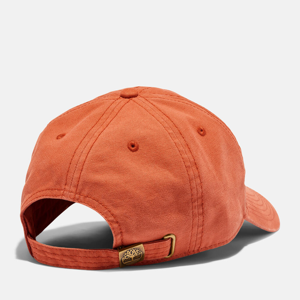 Timberland® Cooper Hill Canvas Baseball Cap in Burnt Sienna. Burnt sienna cotton canvas baseball cap with adjustable strap. Classic design for casual wear and sun protection.