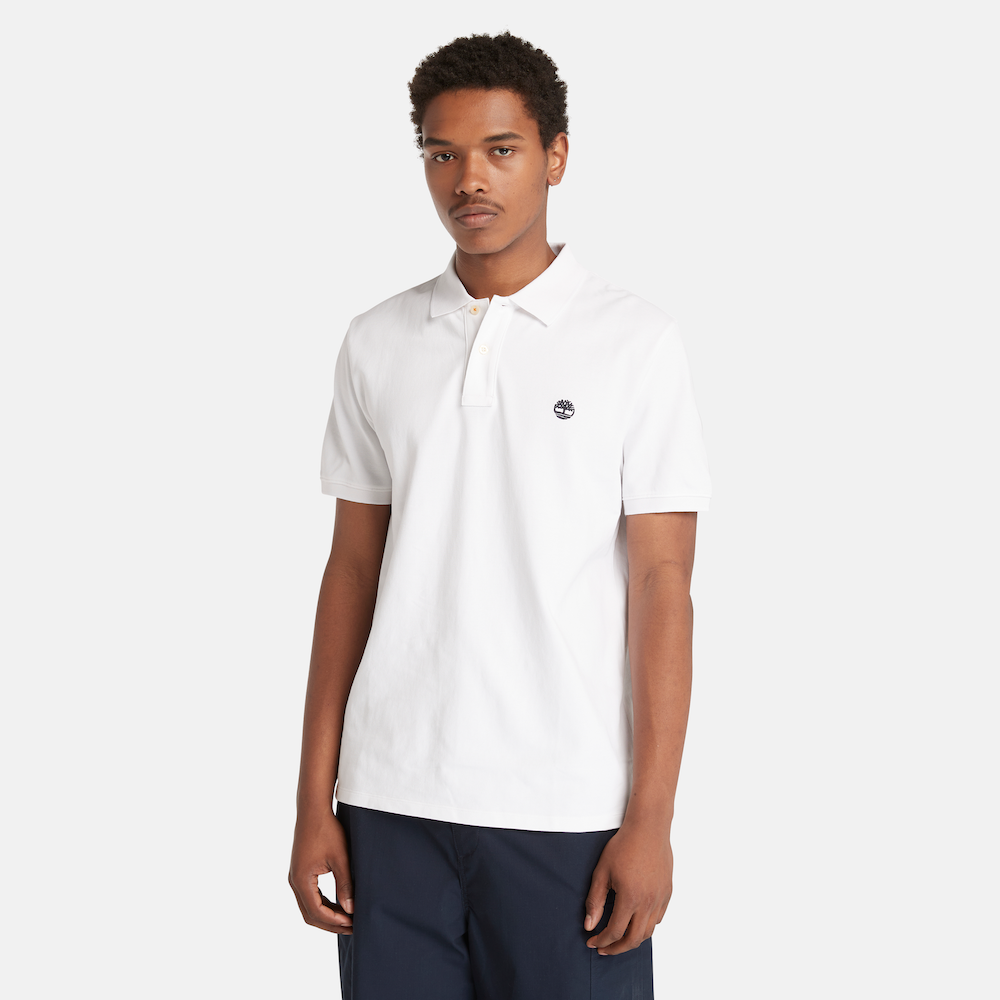 White Timberland® Millers River Pique Polo Shirt for Men. Classic white polo shirt made from 100% organically grown cotton for a comfortable and eco-conscious choice. Relaxed regular fit for comfort. Pique knit fabric for breathability. Ribbed collar and cuffs for a polished look