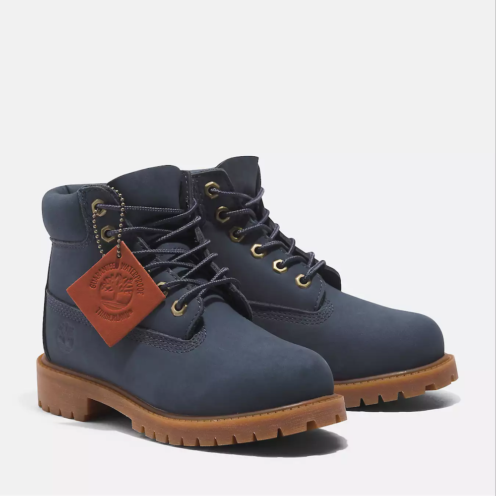 Timberland® Premium 6-Inch Lace Up Waterproof Boot for Junior. Dark blue waterproof boot featuring seam-sealed construction, padded collar for comfort, signature lug sole for traction, and lace-up closure for a secure fit. Perfect for outdoor adventures.