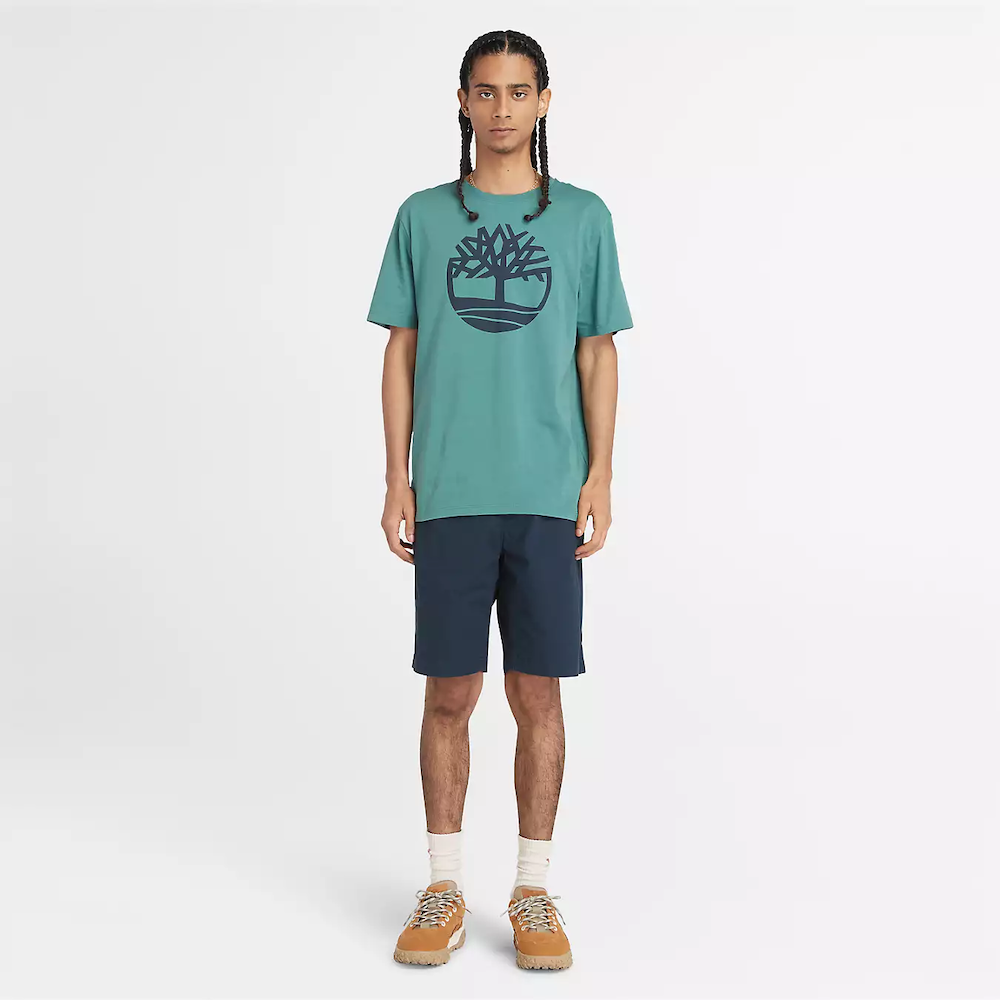 Teal Timberland® Kennebec River Tree Logo T-Shirt for Men. Soft cotton for comfort and breathability. Classic crew neck design. Short sleeves for ventilation. Timberland® tree logo on chest. Vibrant teal color for a pop of style. 