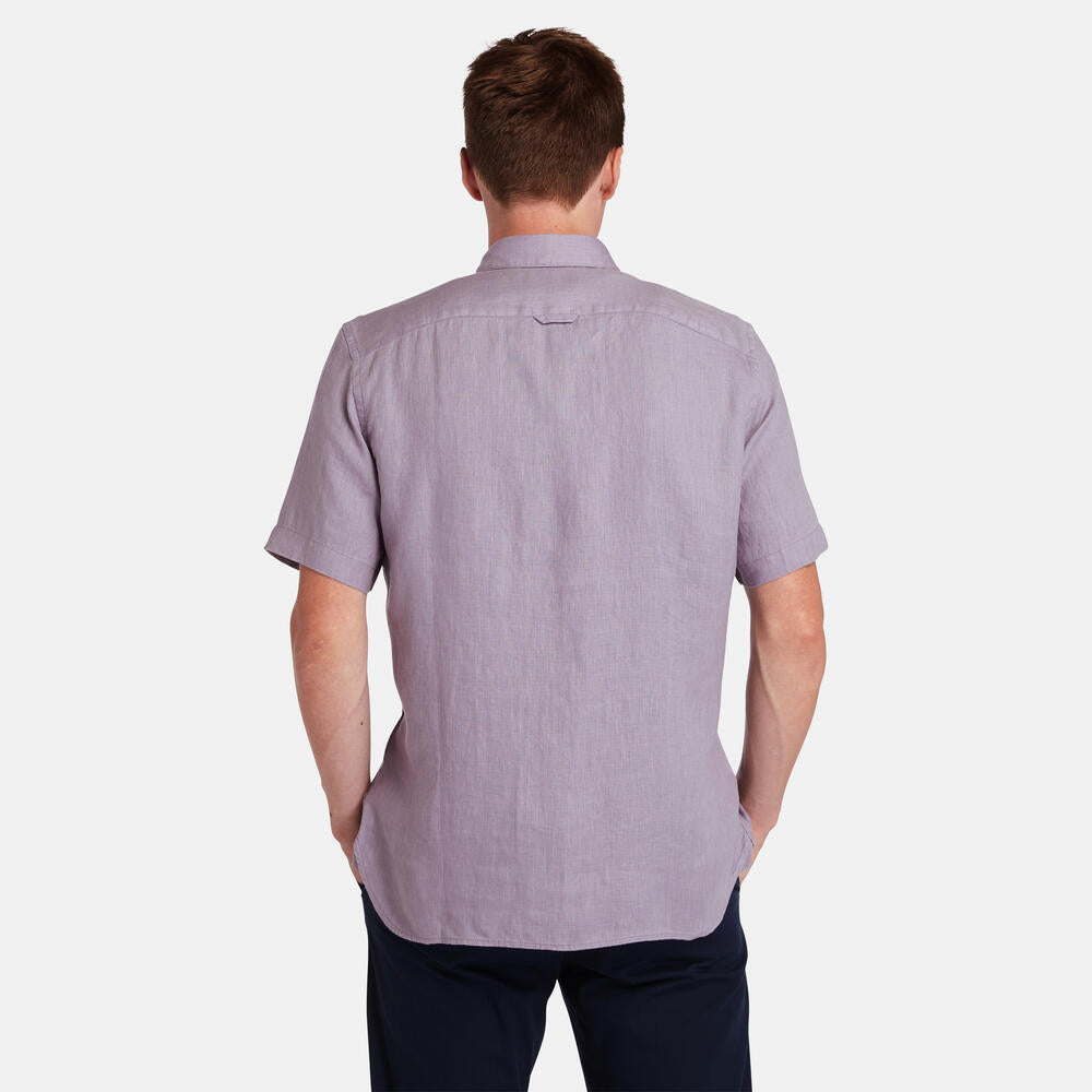 Timberland® Mill Brook Linen Short Sleeve Shirt for Men in Purple. Purple linen shirt with button-down collar and short sleeves. Relaxed fit for a comfortable and stylish look. Perfect for warm weather and casual occasions.