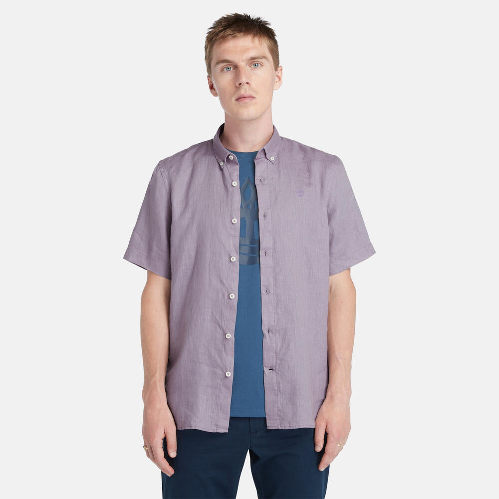 Timberland® Mill Brook Linen Short Sleeve Shirt for Men in Purple. Purple linen shirt with button-down collar and short sleeves. Relaxed fit for a comfortable and stylish look. Perfect for warm weather and casual occasions.