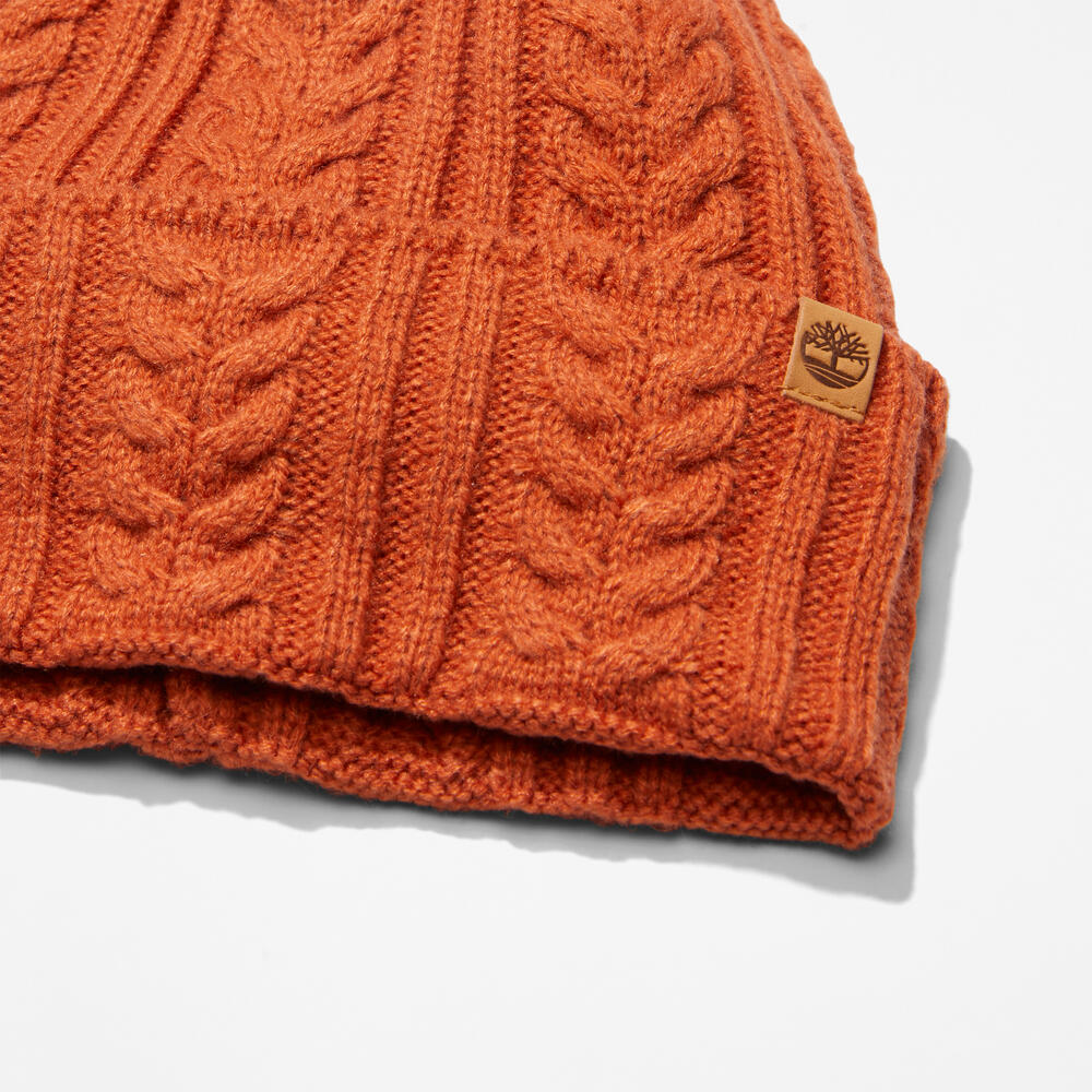 Rust Timberland® Cable Knit Beanie for Women. Soft and chunky cable knit for warmth and texture. Fold-over cuff for adjustability. Rich rust color for earthy appeal.