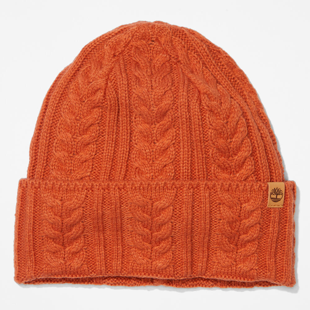 Rust Timberland® Cable Knit Beanie for Women. Soft and chunky cable knit for warmth and texture. Fold-over cuff for adjustability. Rich rust color for earthy appeal.