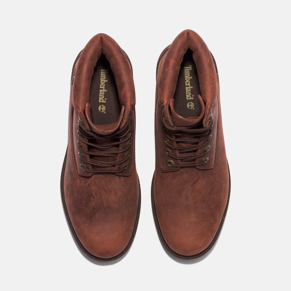 Medium brown Timberland Heritage 6-Inch Waterproof Boot for Men. Premium full-grain leather upper for durability and style. Seam-sealed construction for waterproof protection. Padded leather collar for comfort, lace-up closure for fit. Durable rubber outsole for traction