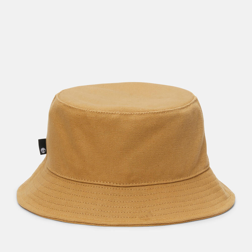 Timberland® Icons of Desire Bucket Hat for Men in Wheat. Classic bucket hat made from 100% cotton for a comfortable and breathable fit. Unstructured design for a relaxed look. Wide brim for sun protection. Wheat color with contrasting dark orange stitch on the sweatband. Anti-microbial treatment for odor control. Versatile and perfect for everyday wear.