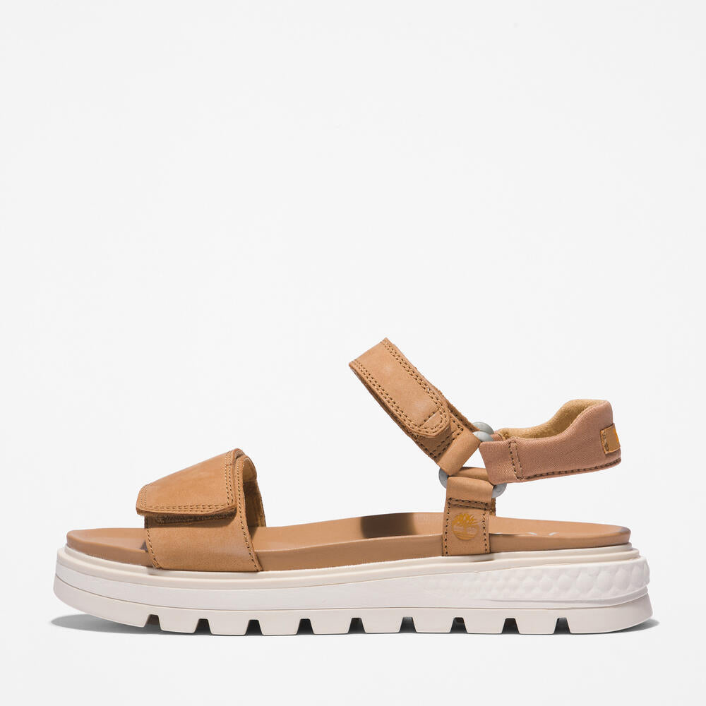 Timberland® Ray City Ankle Strap Sandal for Women in Wheat. Wheat leather sandal with ankle strap, comfortable cushioning, and durable outsole. Versatile for casual wear and urban adventures.