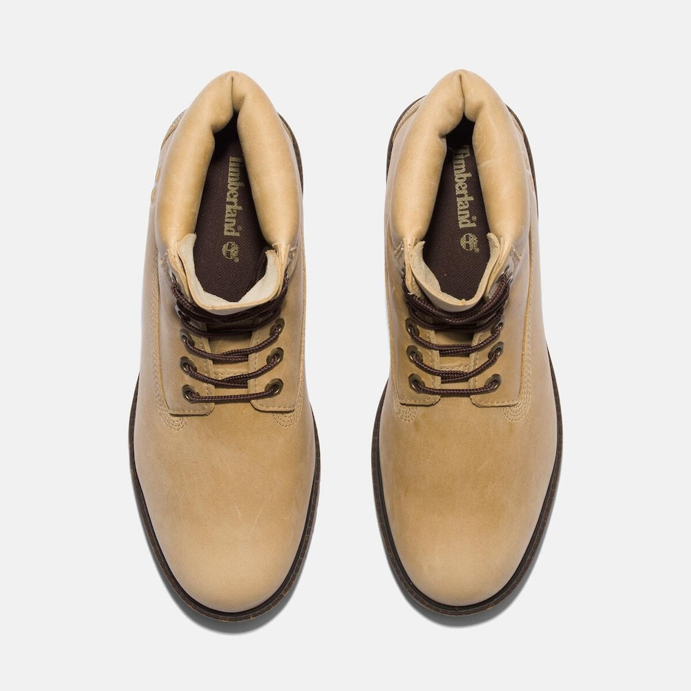 Light beige Timberland Heritage 6-Inch Lace Up Waterproof Boot for Men.  Light beige boot featuring a classic 6-inch silhouette for timeless style.  Made from premium Better Leather sourced from a sustainable tannery rated silver for its environmental processes.  Seam-sealed construction and waterproof membrane ensure dry feet in wet weather.  Features a padded collar for comfort, a lace-up closure for a secure fit, and a lug outsole for reliable traction.