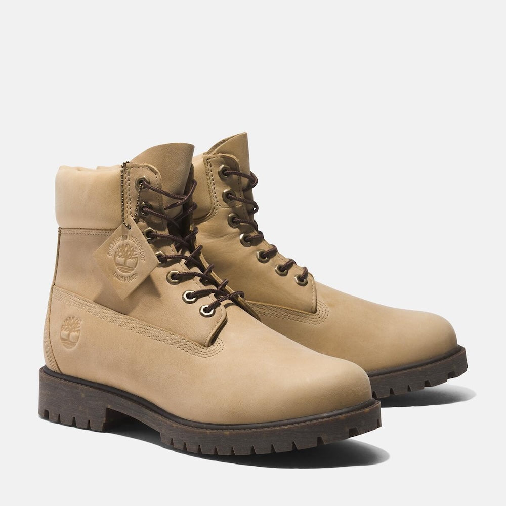 Light beige TimberlandÂ® Heritage 6-Inch Lace Up Waterproof Boot for Men.  Light beige boot featuring a classic 6-inch silhouette for timeless style.  Made from premium Better Leather sourced from a sustainable tannery rated silver for its environmental processes.  Seam-sealed construction and waterproof membrane ensure dry feet in wet weather.  Features a padded collar for comfort, a lace-up closure for a secure fit, and a lug outsole for reliable traction.