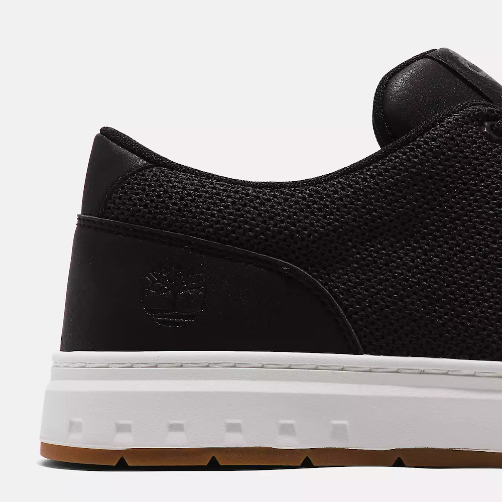 Black Timberland Maple Grove Low Lace-Up Sneaker for Men. Recycled PET upper, lining for comfort. Lace-up fit, flexible midsole. Sleek black upper, durable outsole.