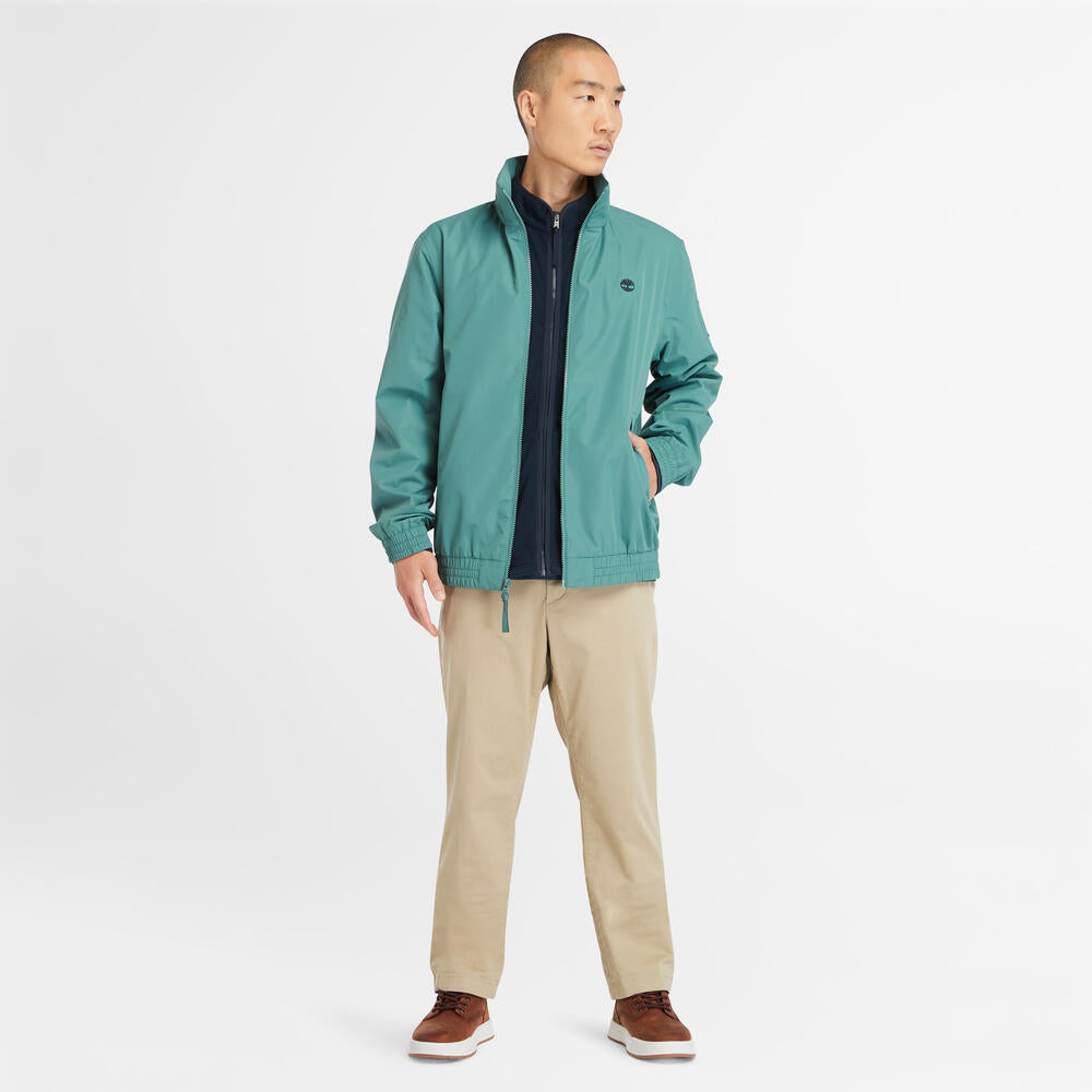 Teal Timberland€š® Water Resistant Bomber Jacket for Men.€šWater-resistant fabric repels moisture.€šDurable construction for long-lasting wear.€šRegular fit for comfort.€šRibbed cuffs and hem for a snug fit.€šButton-up front closure.€šSide pockets and utility sleeve pocket