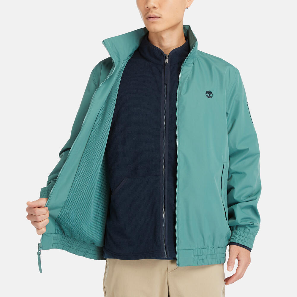 Teal Timberland€š® Water Resistant Bomber Jacket for Men.€šWater-resistant fabric repels moisture.€šDurable construction for long-lasting wear.€šRegular fit for comfort.€šRibbed cuffs and hem for a snug fit.€šButton-up front closure.€šSide pockets and utility sleeve pocket