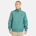 Teal Timberland¡ Water Resistant Bomber Jacket for Men.¡Water-resistant fabric repels moisture.¡Durable construction for long-lasting wear.¡Regular fit for comfort.¡Ribbed cuffs and hem for a snug fit.¡Button-up front closure.¡Side pockets and utility sleeve pocket