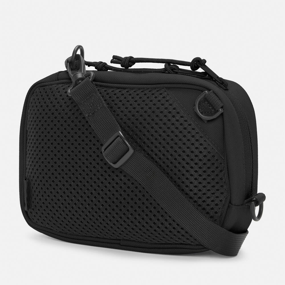 Timberland® Outdoor Archive 2.0 Crossbody Bag in Black. Black crossbody bag made from 100% recycled polyester. Features a large zipper opening, front panel slip pocket with bungee system, adjustable shoulder strap, and two ways to wear. Compact size and lightweight design. Sustainable choice for everyday use.