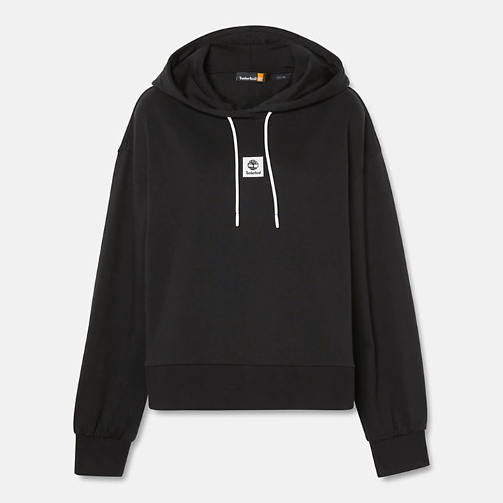 Black Timberland® Women's Loopback Hoodie. Made with 80% cotton for softness and breathability. Dropped-shoulder silhouette for a relaxed, modern look. Drawcord-adjustable hood for warmth and coverage