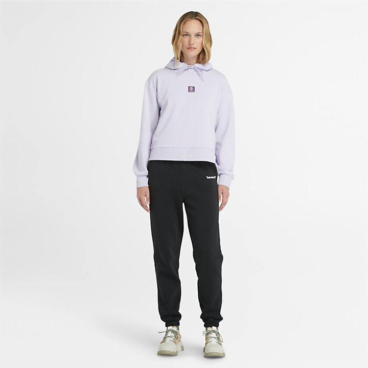 Pastel lilac Timberland Women's Loopback Hoodie. Made with 80% cotton for softness and breathability. Dropped-shoulder silhouette for a relaxed, modern look. Drawcord-adjustable hood for warmth and coverage