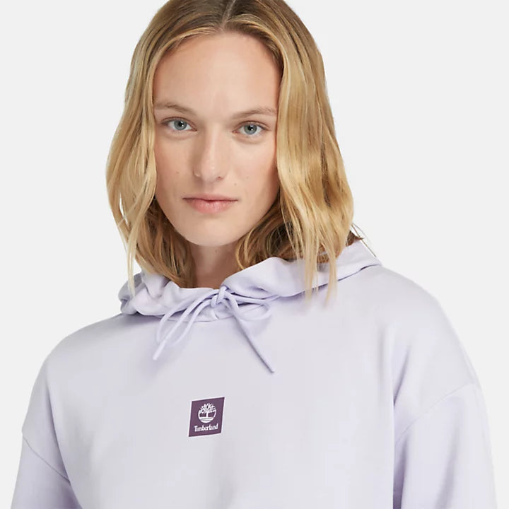 Pastel lilac Timberland Women's Loopback Hoodie. Made with 80% cotton for softness and breathability. Dropped-shoulder silhouette for a relaxed, modern look. Drawcord-adjustable hood for warmth and coverage