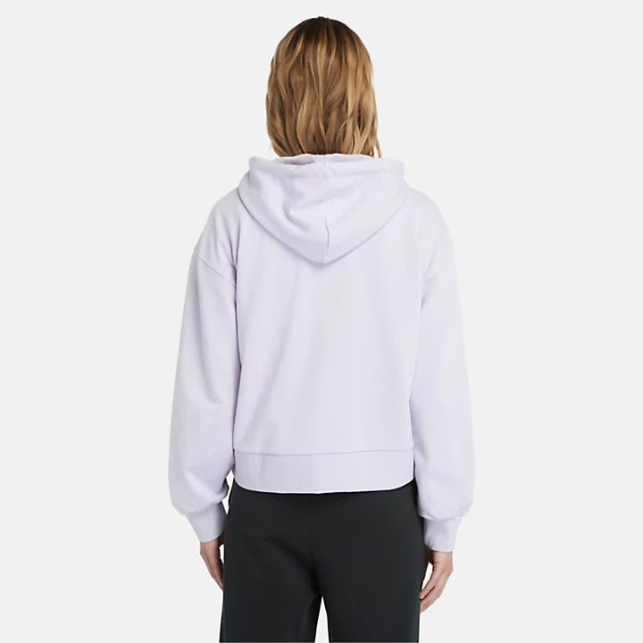 Pastel lilac Timberland Women's Loopback Hoodie. Made with 80% cotton for softness and breathability. Dropped-shoulder silhouette for a relaxed, modern look. Drawcord-adjustable hood for warmth and coverage