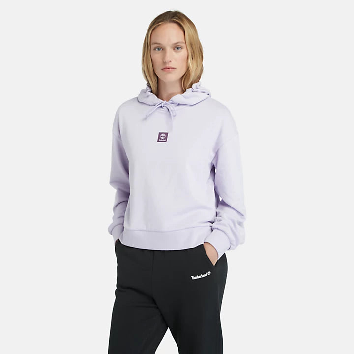 Pastel lilac Timberland Women's Loopback Hoodie. Made with 80% cotton for softness and breathability. Dropped-shoulder silhouette for a relaxed, modern look. Drawcord-adjustable hood for warmth and coverage