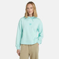 Light blue Timberland Women's Loopback Hoodie. Made with 80% cotton for softness and breathability. Dropped-shoulder silhouette for a relaxed look. Drawcord-adjustable hood for warmth and coverage.