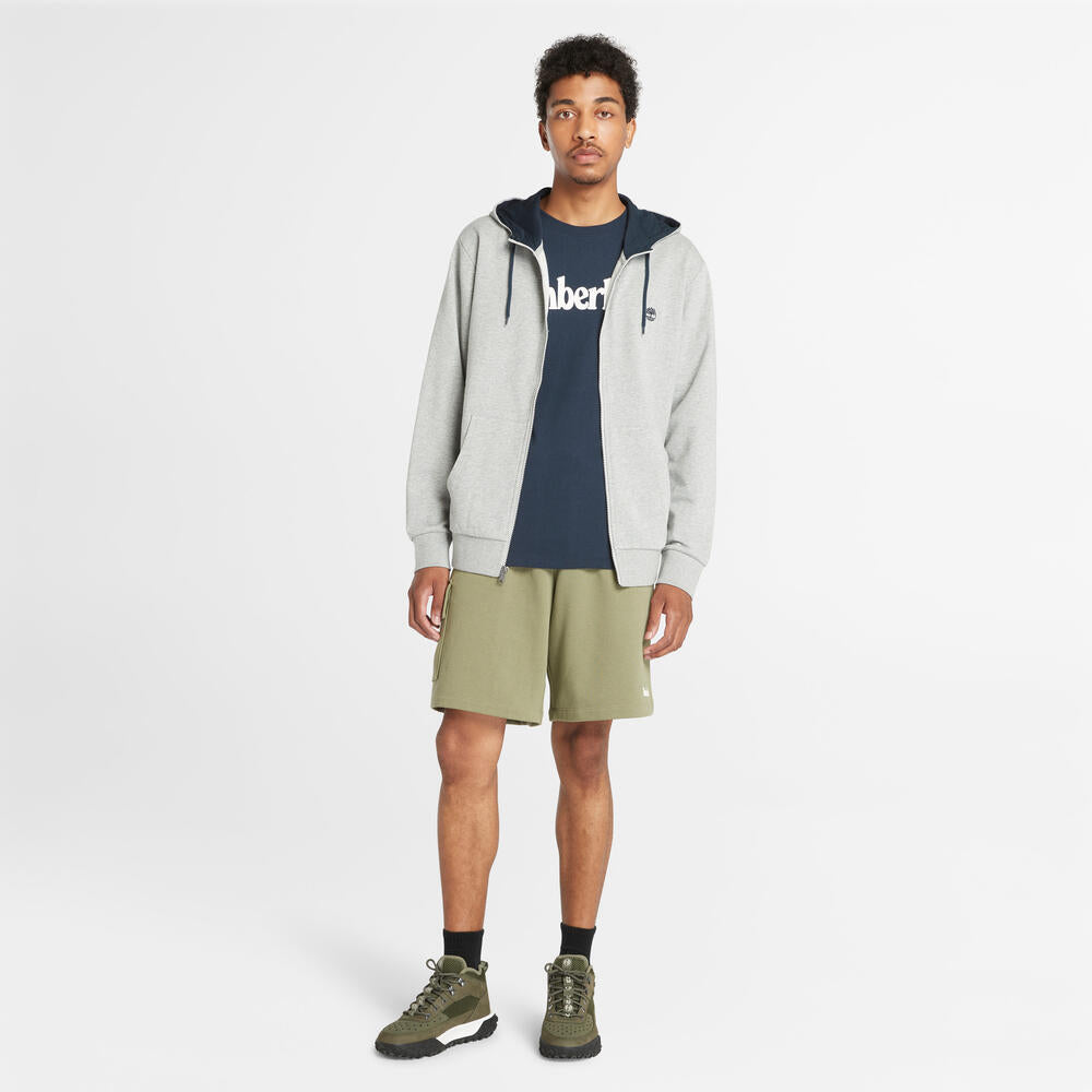 Timberland® Northwood Logo Cargo Brushback Sweatshort. Men's cargo shorts with a brushback interior for warmth. Features cargo pockets and a relaxed fit. Ideal for casual wear and outdoor activities.