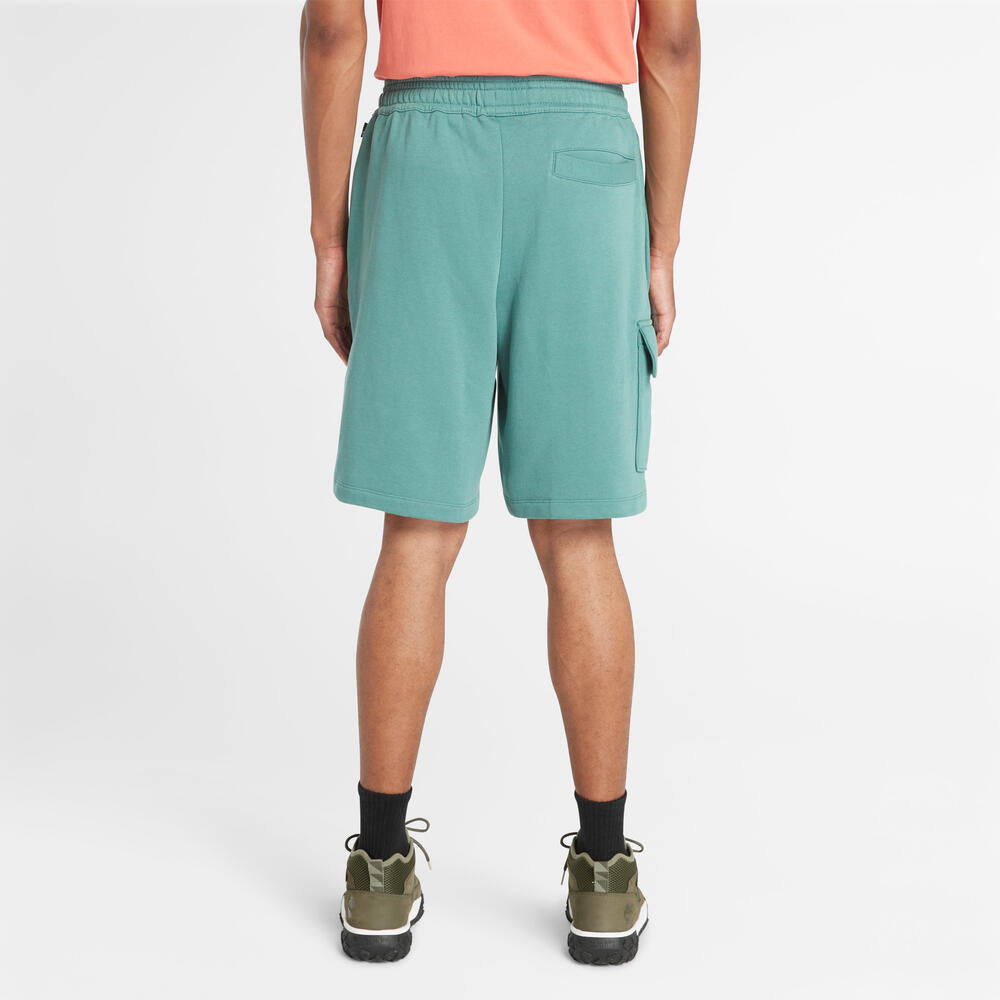 Timberland Northwood Logo Cargo Brushback Sweatshort. Men's cargo shorts with a brushback interior for warmth. Features cargo pockets and a relaxed fit. Ideal for casual wear and outdoor activities.