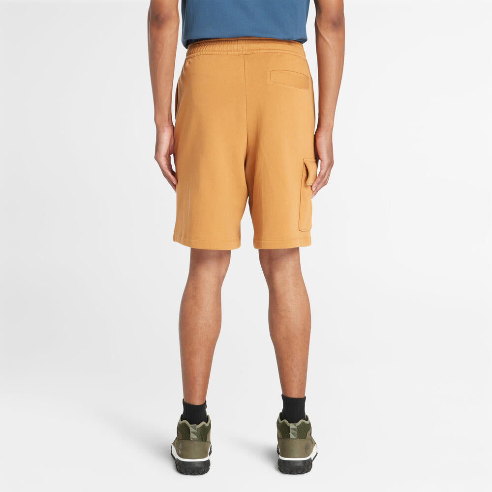 Timberland® Northwood Logo Cargo Brushback Sweatshort. Men's cargo shorts with a brushback interior for warmth. Features cargo pockets and a relaxed fit. Ideal for casual wear and outdoor activities.