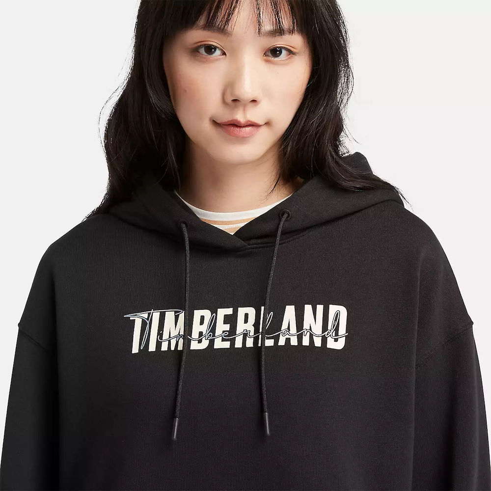 Black Timberland Brushed Back Logo Hoodie for Women. Soft, breathable cotton blend with brushed-back fleece for warmth. Relaxed fit, cropped silhouette (18.0" center back length). Adjustable hood for warmth and coverage. Ribbed cuffs and hem for a snug fit